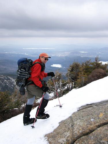 hiker ascending Mount Chocorua in New Hampshire