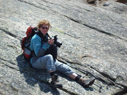 photographer on the summit ledges of Mount Chocorua in New Hampshire