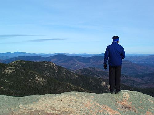 Chuck stands out on the edge taking in the fine summit view from Mount Chocorua in New Hampshire