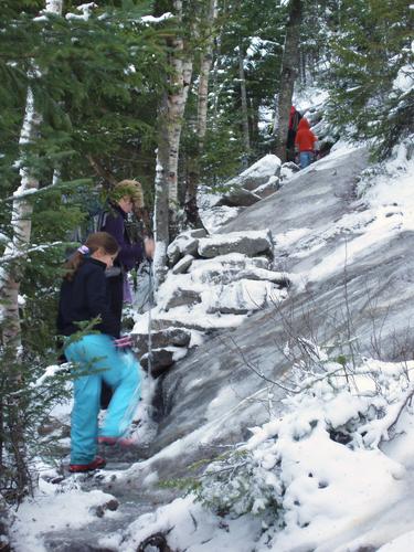 hikers ascending Champney Falls Trail to Mount Chocorua in New Hampshire