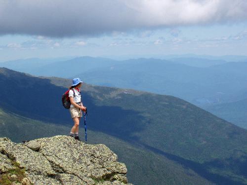 hiker on the edge of Mount Clay's summit in New Hampshire