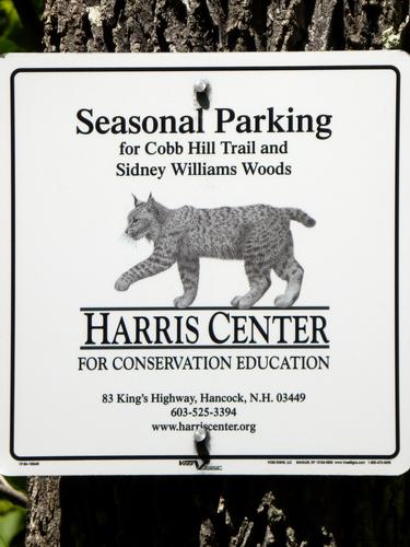 Harris Center sign at the seasonal parking lot for hiking Cobb Hill in New Hampshire