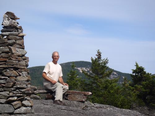 hiker on the summit of Cone Mountain in New Hampshire