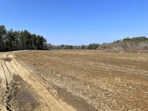 road and field in March at Bonhanan Farm beside Corser Hill near Hopkinton in southern New Hampshire