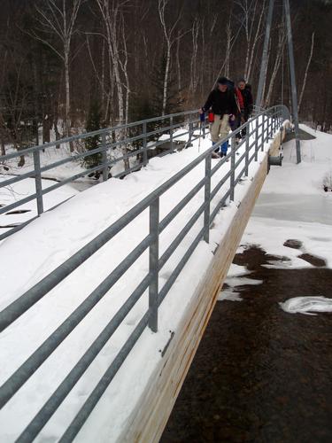 hikers on the suspension bridge at the start of Crawford Path in New Hampshire