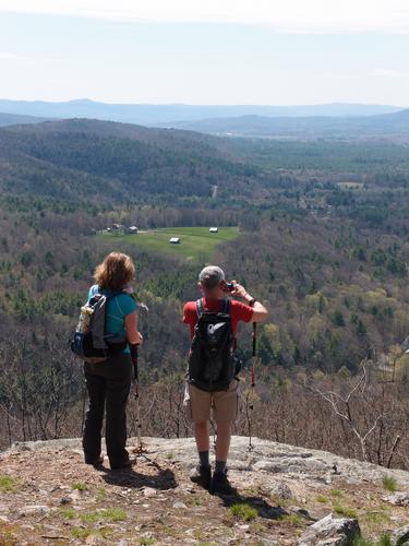 hikers looking into northern Massachusetts and southern Vermont 
from Moon Ledge on the way to Daniels Mountain in southwestern New Hampshire