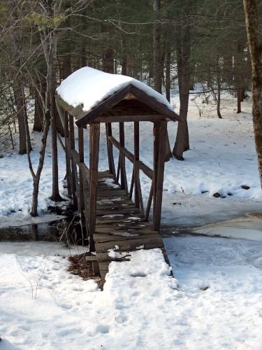 covered footbridge in February on a side trail out of Martel Woods near Darby Brook Conservation Area in New Hampshire