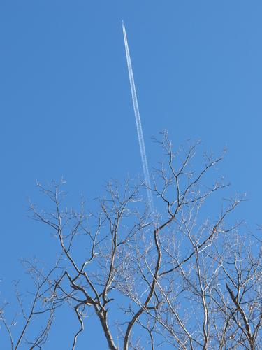 jet contrail above us hikers at Davis Hill in southwestern New Hampshire