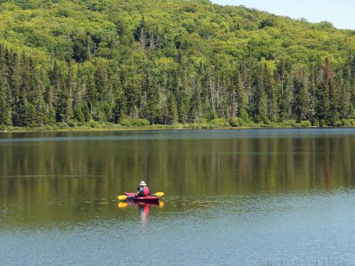 kayaker on Little Diamond Pond near Dead Water Ridge South in northern New Hampshire