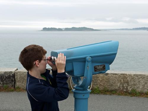 Ryzek checks out the long-distance viewing from the southern tip of Deer Island at Boston Harbor in Massachusetts