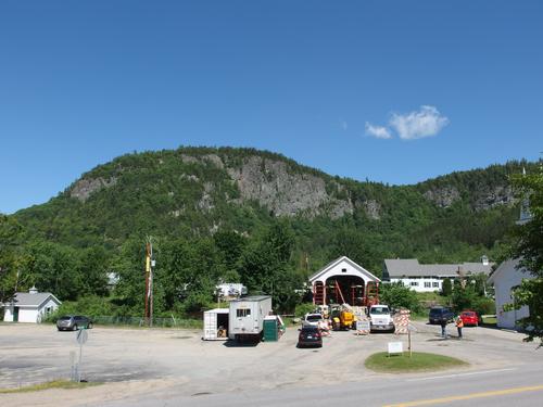 view from Route 110 of Devils Slide looming above the Stark Covered Bridge (under construction) in northern New Hampshire