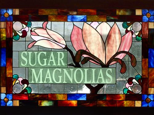window sign for Sugar Magnolias restaurant near Dogtown at Gloucester in Massachusetts