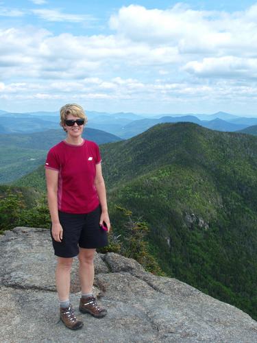 hiker atop Mount Osceola in New Hampshire