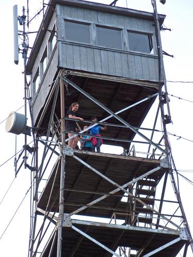 hikers on the fire lookout tower atop Federal Hill in southern New Hampshire