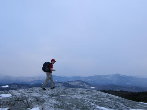 hiker at dusk atop Foss Mountain in New Hampshire