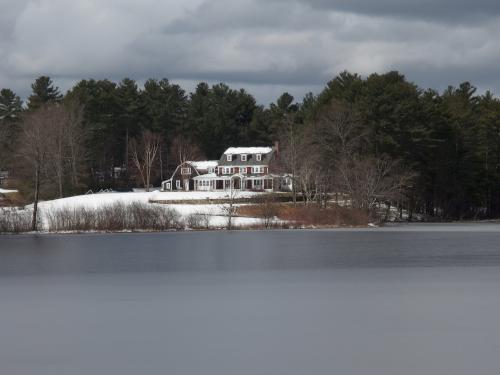 picturesque house in March on Greenough Pond near Foss Farm in northeastern Massachusetts