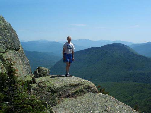 hiker and summit view south from Mount Garfield in New Hampshire