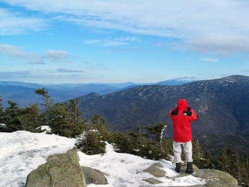 hiker and summit view east from Mount Garfield in New Hampshire