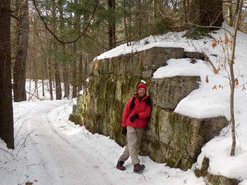 winter hiker on the Granite Town Rail Trail in New Hampshire