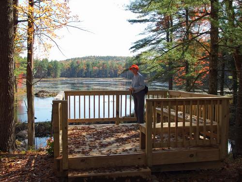 Joan stands out on the overview deck beside Beaver Ponds within Grater Woods at Merrimack in southern New Hampshire