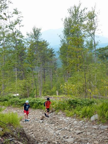 young hikers on the access road to Green Mountain near Claremont in New Hampshire