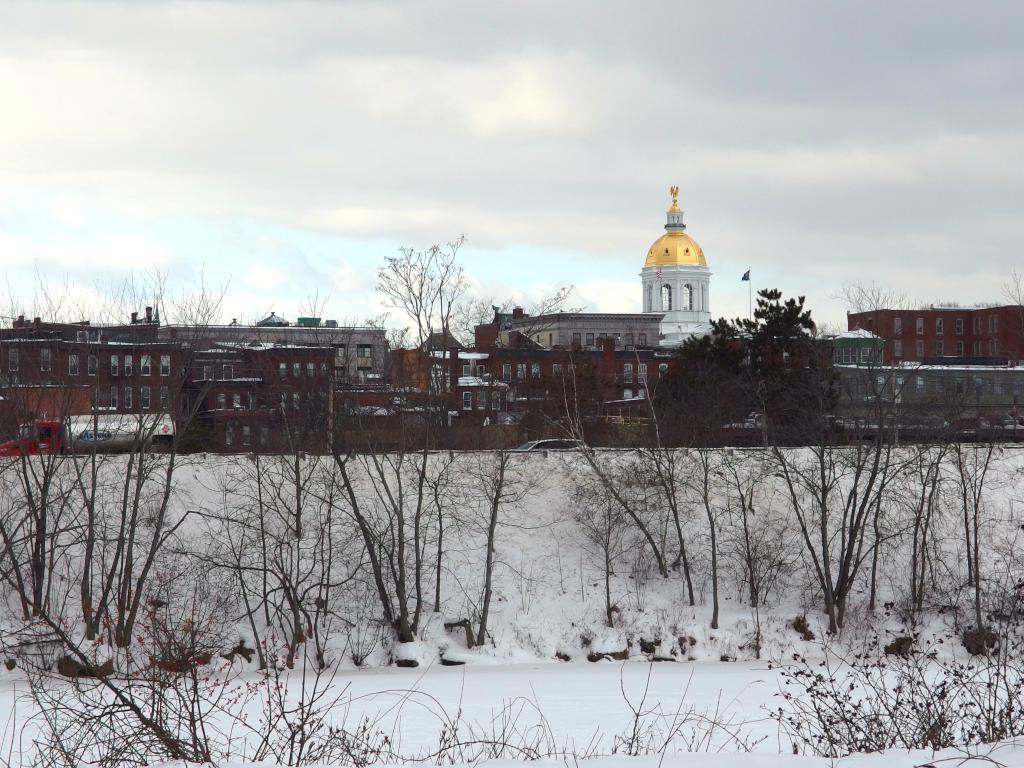 view of the NH State House in January from the Merrimack River Greenway Trail near Concord in southern New Hampshire