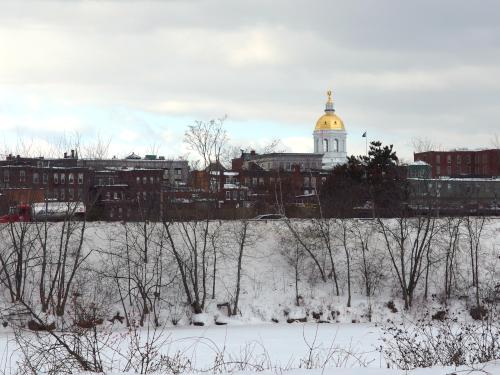 view of the NH State House in January from the Merrimack River Greenway Trail near Concord in southern New Hampshire