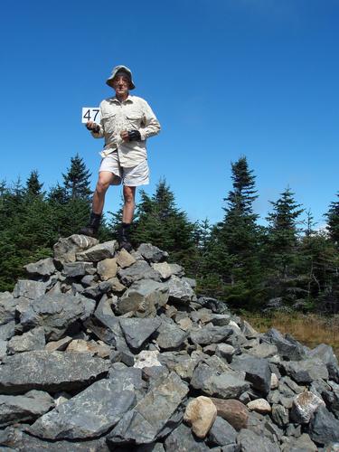 hiker on the summit of Mount Hale in New Hampshire