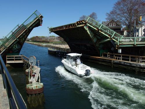 boat passing under Blynman Bridge at Gloucester in northeastern Massachusetts