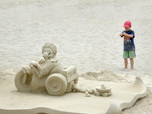a young artist-to-be gets up close with the last entry 
in a sand sculpture parade at Hampton Beach in New Hampshire