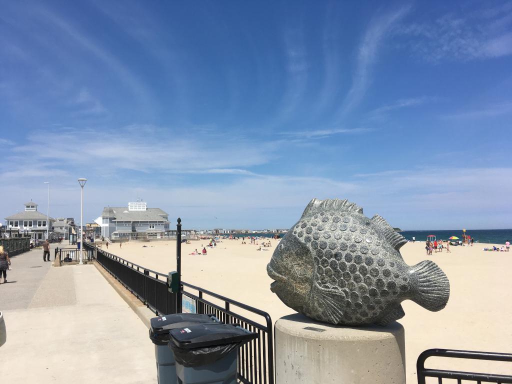 fish statue and view of Hampton Beach in June in New Hampshire