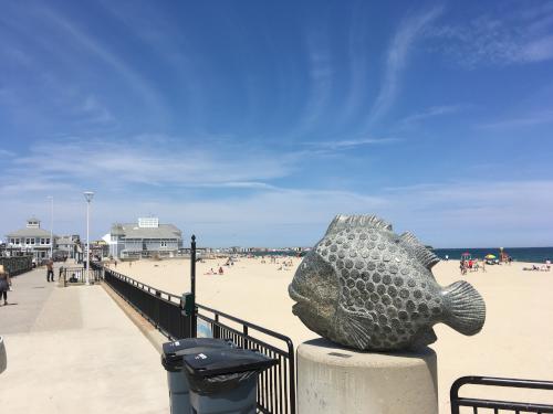 fish statue and view of Hampton Beach in June in New Hampshire