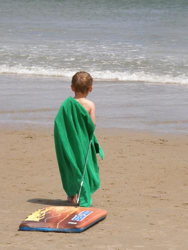 a boy approaches the surf at Hampton Beach in New Hampshire
