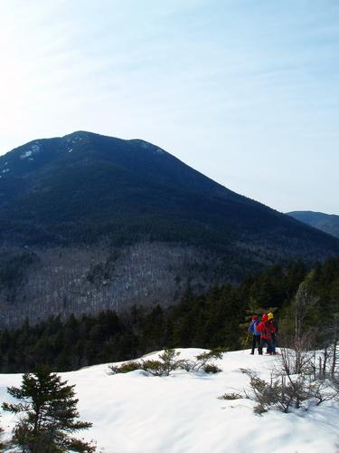 hikers on Hedgehog Mountain looking out toward Mount Passaconaway in New Hampshire
