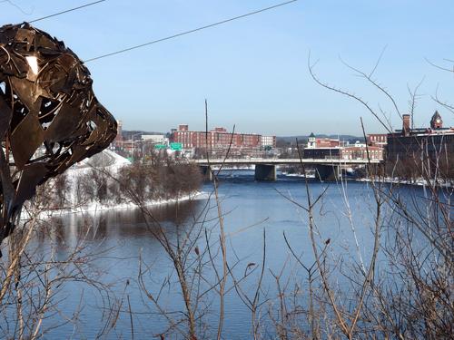 modern-art bull statue and view up the Merrimack River at the start of the Piscataquog Trail at Manchester in New Hampshire