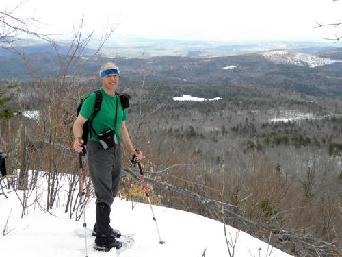 hiker at a viewpoint on Hersey Mountain in New Hampshire