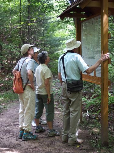 hikers check out an information kiosk at Horse Hill Nature Preserve in New Hampshire