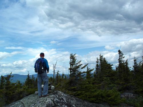 hiker near the summit of Howe Peak in New Hampshire