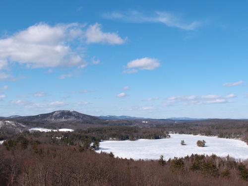 view from the summit of Mount Hunger looking over Stodge Meadow Pond toward Mount Watatic in Massachusetts