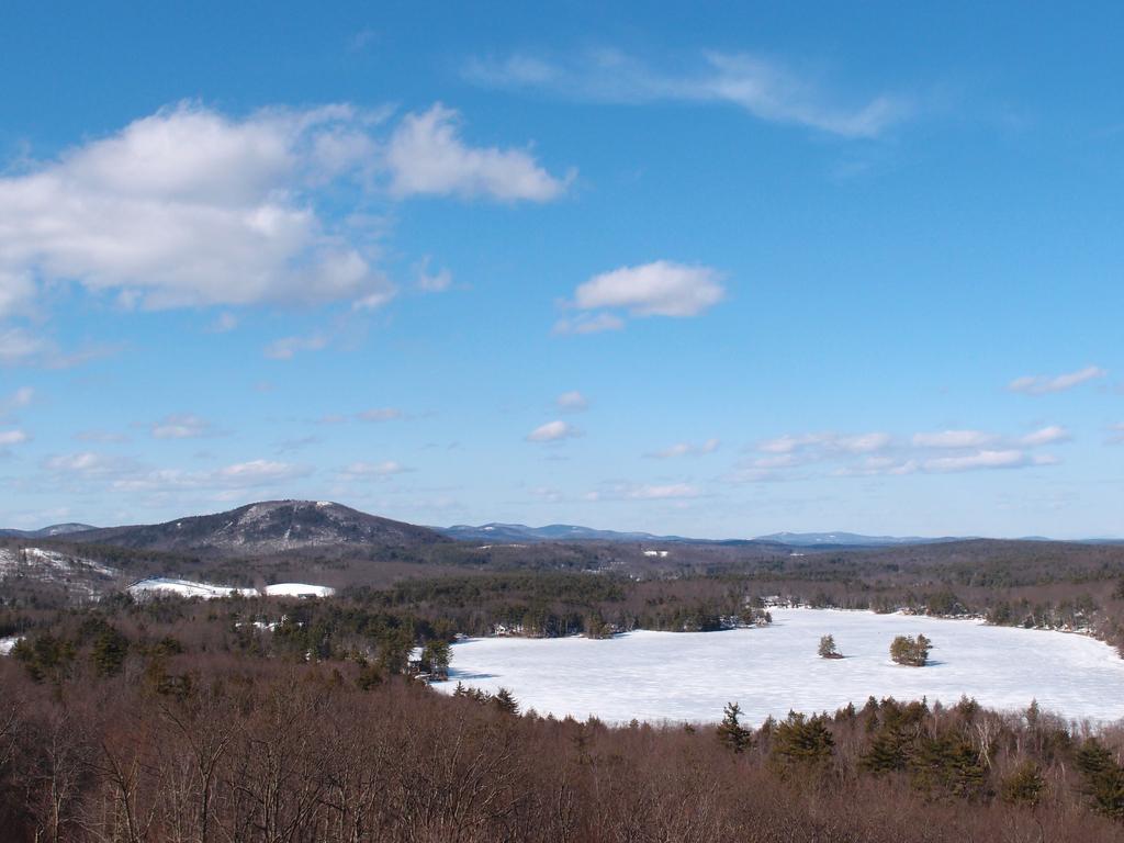 view from the summit of Mount Hunger looking over Stodge Meadow Pond toward Mount Watatic in Massachusetts