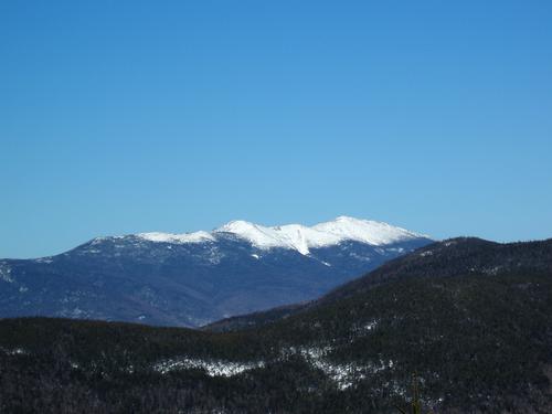 snow-capped Franconia Ridge as seen from West Huntington Mountain in New Hampshire