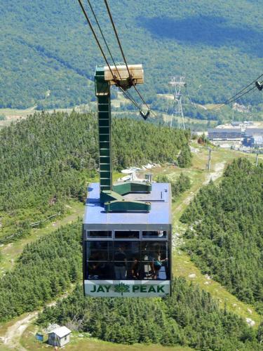 a bunch of tourists descend the easy way via gondola from the summit of Jay Peak in Vermont