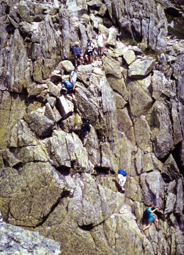 hikers in June on the Knife Edge trail on Mount Katahdin in Maine
