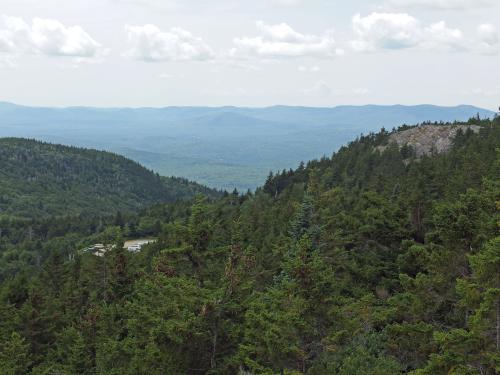 view from Rollins Trail of the parking lot and Lincoln Trail cliff at Mount Kearsarge in New Hampshire