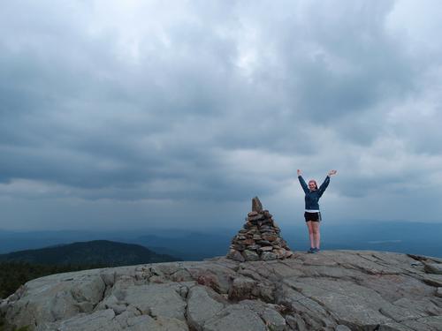 hiker on the sub peak of Mount Kearsarge in New Hampshire before incoming bad weather