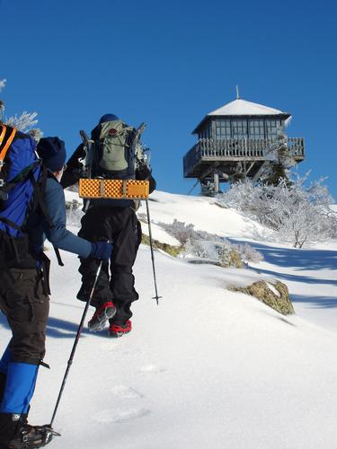 hikers approach the summit tower on Kearsarge North in New Hampshire