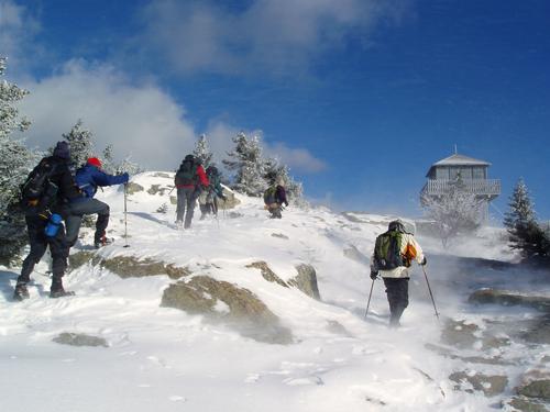 hikers reach the wintery summit of Kearsarge North in New Hampshire
