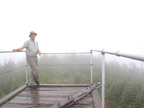 hiker in the fog atop Kibby Mountain in Maine
