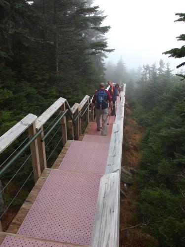 hikers on the Catwalk at the summit of  Killington Peak in Vermont