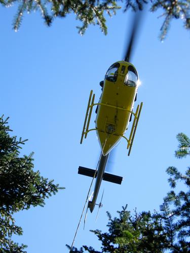 airlift helicopter above Kinsman Pond Shelter in New Hampshire